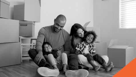 young family sitting on floor laughing